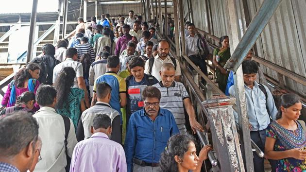 People take the foot overbridge where a stampede happened at the Elphinstone Road railway station in Mumbai on Friday. (Satyabrata Tripathy/HT Photo) People take the foot overbridge where a stampede happened at the Elphinstone Road railway station in Mumbai on Friday. (Satyabrata Tripathy/HT Photo)