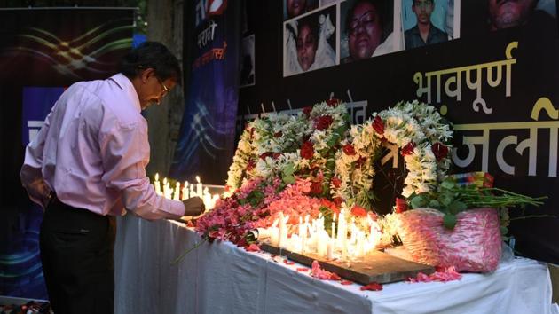 A man lights a candle in memory of the 23 people who died in a rush-hour stampede at Elphinstone Road station(Samson Tupdal/HT Photo)