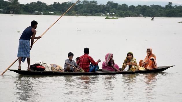 Villagers shift from a flood-hit area in Bolbola in Goalpara, Assam, on Sunday. (PTI Photo) Villagers shift from a flood-hit area in Bolbola in Goalpara, Assam, on Sunday. (PTI Photo)