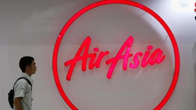 A man walks past the logo of AirAsia at Don Muang International Airport in Bangkok, Thailand. (Reuters File)