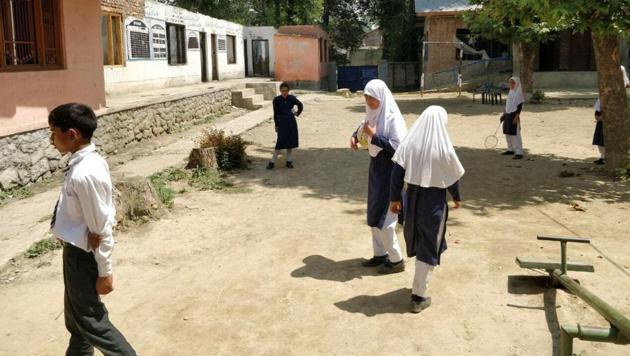 After their schools were burnt by unidentified men during protests over Burhan Wani’s killing, Kashmiri students struggle to study in classrooms with broken roofs and windows, blackened walls; the government is yet to complete the reconstruction and repair work. (Neelam Pandey / HT Photo)