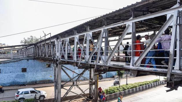 According to railway officials, the new foot overbridge (FOB) being constructed on the Raja Bahadur Mill road side will be ready only by the next financial year, as lack of funds has delayed the work.(HT PHOTO)