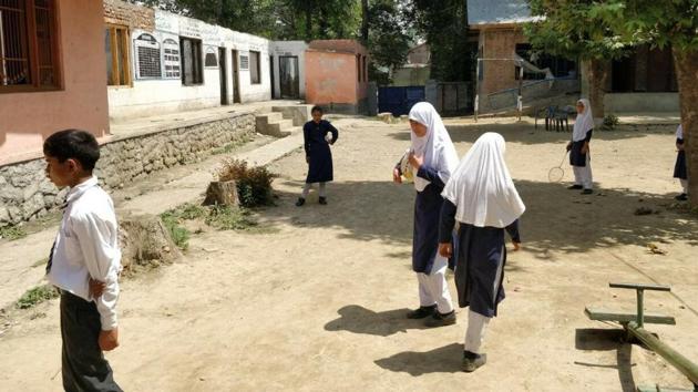 Children play at Batengoo school in Anantnag, Kashmir. Eight of its 14 classrooms were burnt by unidentified people last year.(Neelam Pandey/HT Photo)
