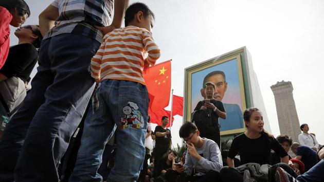 Visitors rest near a portrait of Sun Yat-sen at Tiananmen Square, China. Widely regarded as the ‘Father of Nation’ in the Republic of China (ROC), Sun Yat-sen served as the nation’s first president known to have played an instrumental role in overthrowing the Quin Dynasty. (Andy Wong / AP) Visitors rest near a portrait of Sun Yat-sen at Tiananmen Square, China. Widely regarded as the ‘Father of Nation’ in the Republic of China (ROC), Sun Yat-sen served as the nation’s first president known to have played an instrumental role in overthrowing the Quin Dynasty. (Andy Wong / AP)