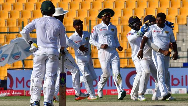 Sri Lanka's Rangana Herath (R) celebrates after dismissing Pakistan's Mohammad Amir on the fifth day of the first cricket Test at Sheikh Zayed Stadium in Abu Dhabi on October 2, 2017. (AFP) Sri Lanka's Rangana Herath (R) celebrates after dismissing Pakistan's Mohammad Amir on the fifth day of the first cricket Test at Sheikh Zayed Stadium in Abu Dhabi on October 2, 2017. (AFP)
