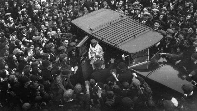 An admiring East End crowd gathered to witness the arrival of Mahatma Gandhi in Canning Town, East London, as he called upon Charlie Chaplin in 1931. Gandhi was in England in his capacity as leader of the Indian National Congress attending the London Round Table Conference on Indian constitutional reforms. (London Express / Getty Images)