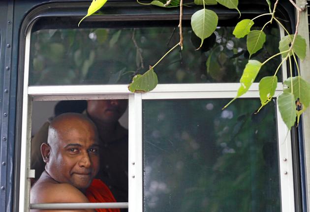 Sri Lanka's Buddhist monk Akmeemana Dayarathana, who led hardline nationalists in an unruly protest against Rohingya Muslim asylum seekers last week, looks out from a prison bus in Mount Lavinia, Sri Lanka on October 2. (REUTERS) Sri Lanka's Buddhist monk Akmeemana Dayarathana, who led hardline nationalists in an unruly protest against Rohingya Muslim asylum seekers last week, looks out from a prison bus in Mount Lavinia, Sri Lanka on October 2. (REUTERS)