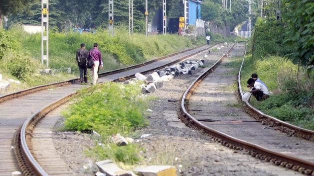 Men engaging in open defecation near the Pune station in Pune on Monday. (Rahul Raut/HT PHOTO) Men engaging in open defecation near the Pune station in Pune on Monday. (Rahul Raut/HT PHOTO)