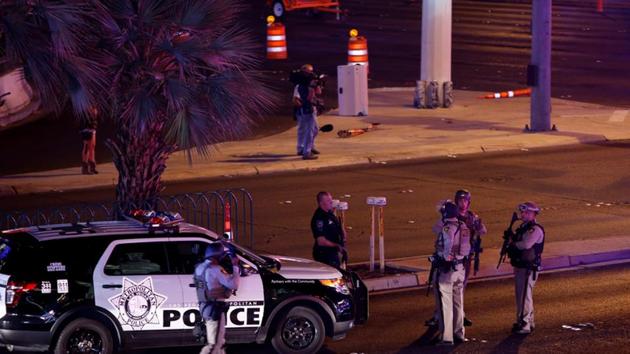 Las Vegas Metro Police officers gather near the intersection of Tropicana Avenue and Las Vegas Boulevard South after a mass shooting at a music festival.(REUTERS)