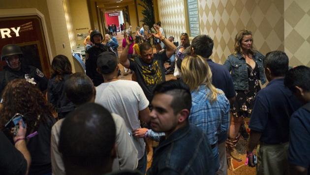 People are searched by Las Vegas police at the Tropicana Las Vegas. The concert venue was in an outdoor area known as Las Vegas Village, across the Strip from the Mandalay Bay and the Luxor hotels. (Chase Stevens / AP) People are searched by Las Vegas police at the Tropicana Las Vegas. The concert venue was in an outdoor area known as Las Vegas Village, across the Strip from the Mandalay Bay and the Luxor hotels. (Chase Stevens / AP)