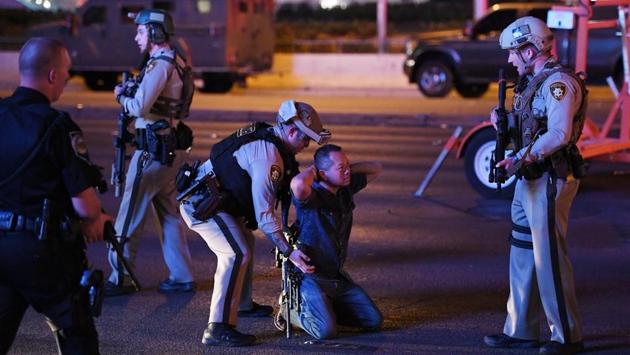 A gunman killed over 50 people and wounded more than 200 at a country music festival on the Las Vegas Strip on Sunday, raining down rapid fire from the 32nd floor of a hotel for several minutes before he was shot dead by police. The death toll would make the attack the deadliest mass shooting in US history, eclipsing last year’s massacre of 49 people at an Orlando night club. (Ethan Miller / AFP) A gunman killed over 50 people and wounded more than 200 at a country music festival on the Las Vegas Strip on Sunday, raining down rapid fire from the 32nd floor of a hotel for several minutes before he was shot dead by police. The death toll would make the attack the deadliest mass shooting in US history, eclipsing last year’s massacre of 49 people at an Orlando night club. (Ethan Miller / AFP)
