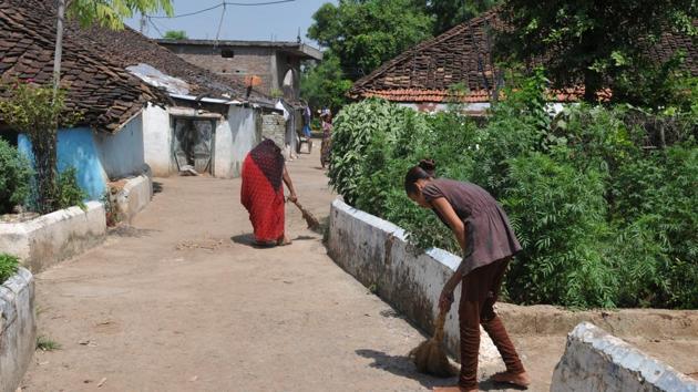 Villagers cleaning roads near their houses in model village Baghuvar in Narsinghpur district of Madhya Pradesh. (Mujeeb Faruqui/HT Photo) Villagers cleaning roads near their houses in model village Baghuvar in Narsinghpur district of Madhya Pradesh. (Mujeeb Faruqui/HT Photo)