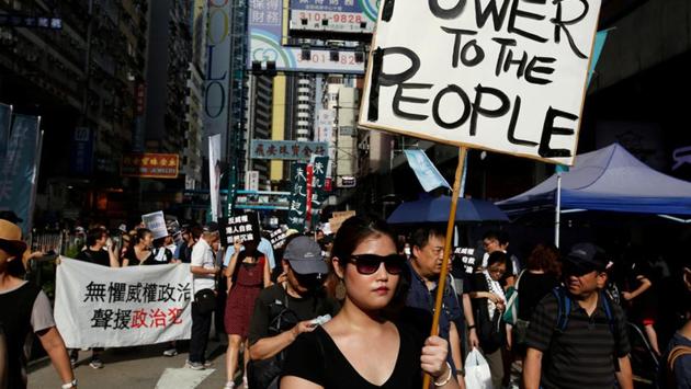 Thousands of pro-democracy supporters also took to the streets of Chinese-controlled Hong Kong to protest against political prosecution while carrying banners calling for the rejection of ‘authoritarian rule’ and demanded the city’s Justice Secretary Rimsky Yuen to step down. (Bobby Yip / REUTERS) Thousands of pro-democracy supporters also took to the streets of Chinese-controlled Hong Kong to protest against political prosecution while carrying banners calling for the rejection of ‘authoritarian rule’ and demanded the city’s Justice Secretary Rimsky Yuen to step down. (Bobby Yip / REUTERS)