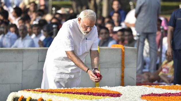 Prime Minister Narendra Modi pays tribute to Mahatma Gandhi on his 148th birth anniversary at Rajghat in New Delhi on Monday. (Raj K Raj/HT Photo) Prime Minister Narendra Modi pays tribute to Mahatma Gandhi on his 148th birth anniversary at Rajghat in New Delhi on Monday. (Raj K Raj/HT Photo)