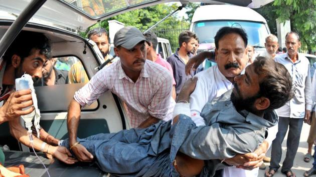 An injured being shifted to a government medical college for a treatment in Jammu on Monday after Pakistan targeted Indian villages and posts with heavy gunfire and mortar shells.(HT File)