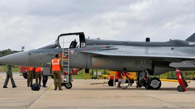 Airport ground staff stand besides Tejas, India's first locally-built Light Combat Aircraft (LCA) designed by Aeronautical Development Agency and Hindustan Aeronautics Limited. (REUTERS)
