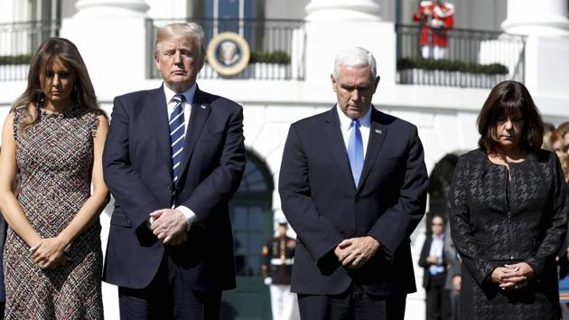 President Donald Trump and first lady Melania Trump stood with vice president Mike Pence and his wife Karen during a moment of silence to remember the victims of the mass shooting in Las Vegas, on the South Lawn of the White House in Washington. (AP)