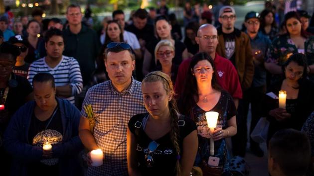 Mourners attend a candlelight vigil at the corner of Sahara Avenue and Las Vegas Boulevard for the victims of Sunday night's mass shooting, in what transpired to be one of the deadliest mass shooting in American history killing atleast 59 and injuring over 500 people. (Drew Angerer / AFP)