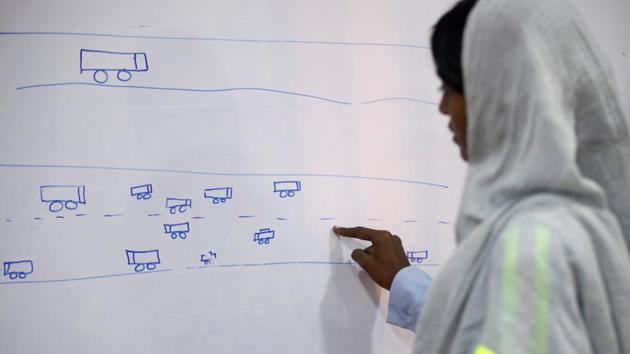 The training program for women is elaborate as they are taught to familiarize themselves with the path of the trucks that they will eventually drive among other technical details. (Akhtar Soomro / REUTERS)