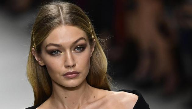Model Gigi Hadid wearing barrettes while presenting a creation for Versace.(AFP)