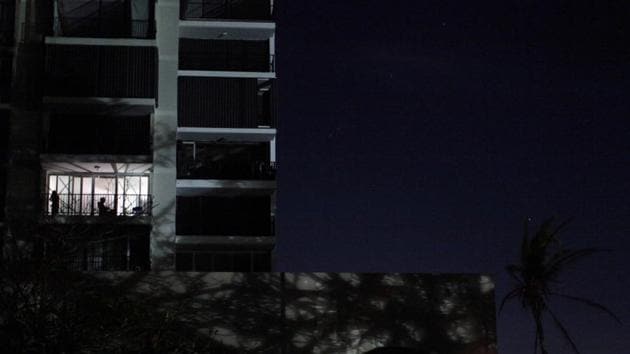 Local residents sit at their apartment's balcony as areas of San Juan are still left without electricity following Hurricane Maria in Guaynabo, Puerto Rico. Residents are without cell phone signals and fuels for their generators and cars. About 88 percent of cellphone sites are still out of service. (Alvin Baez / REUTERS)