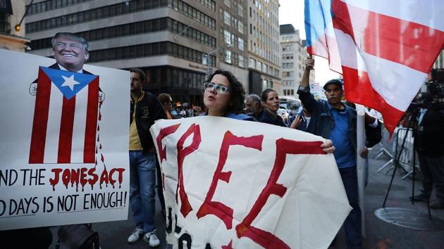 People rally outside of Trump Tower in support of Puerto Rico in New York. The protesters were critical of the Trump administration's response to the storm. (Spencer Platt / AFP)