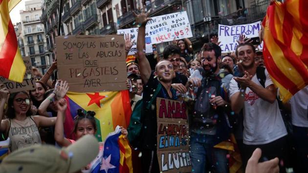 Young people wave Catalan pro-independence ‘Estelada’ flags and a placard reading ‘We are the granddaughters of the grandmothers you beat yesterday’ in Barcelona during a demonstration on a general strike day in Catalonia called by Catalan unions. Large numbers of Catalans observed a general strike to condemn police violence at a banned weekend referendum on independence. (Pau Barrena / AFP) Young people wave Catalan pro-independence ‘Estelada’ flags and a placard reading ‘We are the granddaughters of the grandmothers you beat yesterday’ in Barcelona during a demonstration on a general strike day in Catalonia called by Catalan unions. Large numbers of Catalans observed a general strike to condemn police violence at a banned weekend referendum on independence. (Pau Barrena / AFP)