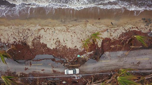 A car drives on a damaged road in the aftermath of Hurricane Maria in Humacao, Puerto Rico. Two weeks after it was hit by the worst hurricane in 90 years, many of Puerto Rico’s 3.4 million residents are still struggling with basic necessities. (Ricardo Arduengo / AFP)