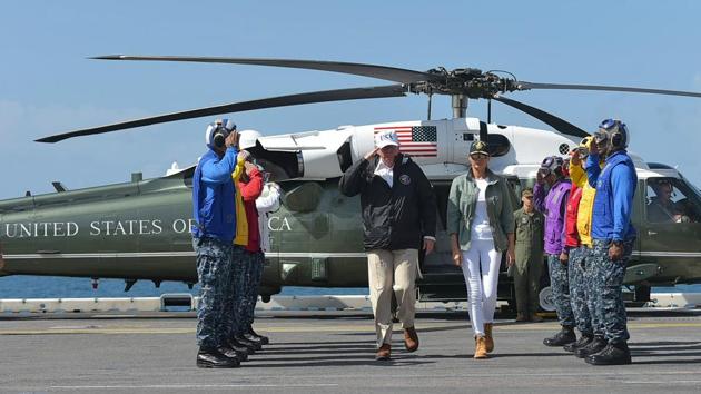 US President Donald Trump and First Lady Melania Trump (R) are greeted upon arrival on the USS Kearsarge, off Puerto Rico. Trump who has grappled with hurricanes Harvey, Irma and Maria in the past six weeks, said at a briefing that the disasters were straining the U.S. budget. (Mandel Ngan / AFP)