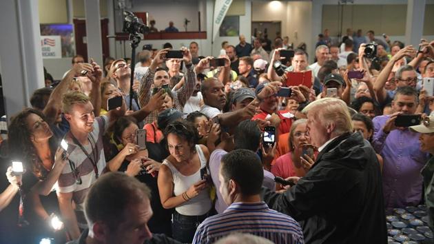 US President Donald Trump and First Lady Melania Trump (R) take part in a food and supply distribution at the Cavalry Chapel in Guaynabo, Puerto Rico. The U.S. territory’s economy was already in recession before Hurricane Maria and its government had filed for bankruptcy in the face of a $72 billion debt load. In an interview with Fox News, Trump said the island’s debt would be erased. (Mandel Ngan / AFP)