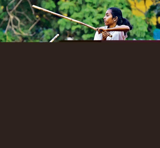 Anushka Mane (front) and Sakshi Patil display the prowess with the single stick, a type of Silambam weapon, in Pune.(Pratham Gokhale/HT Photo)