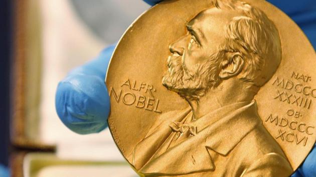 A national library employee shows the gold Nobel Prize medal awarded to the late novelist Gabriel Garcia Marquez, in Bogota, Colombia.(AP File Photo)