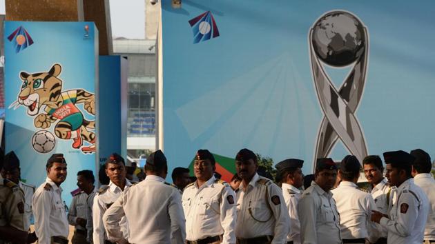 Indian policemen stand near the poster of FIFA U-17 football World trophy at The D.Y. Patil stadium in Navi Mumbai. (AFP)