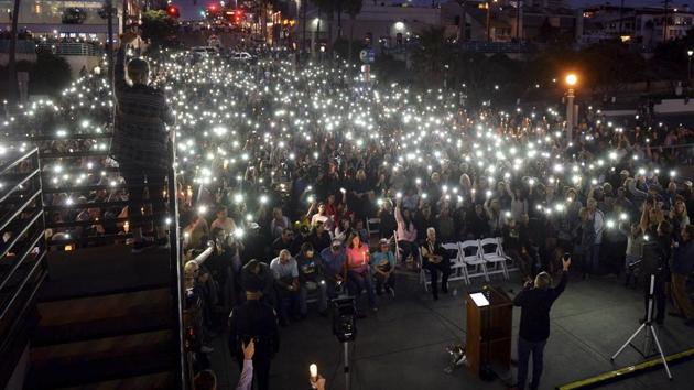 Cell phones and candles light the night during a vigil at the Manhattan Beach Pier, honouring victims in the Las Vegas mass shooting, in Manhattan Beach, California on October 4. (AP Photo)