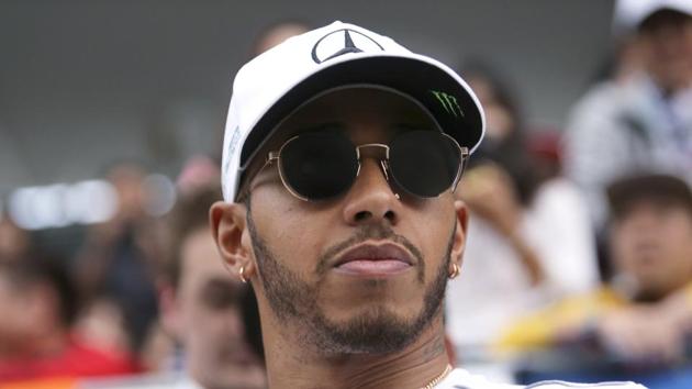 Mercedes driver Lewis Hamilton leaves the spectators stand after meeting fans at Suzuka Circuit on Thursday ahead of Sunday's Formula One Japanese Grand Prix. (AP) Mercedes driver Lewis Hamilton leaves the spectators stand after meeting fans at Suzuka Circuit on Thursday ahead of Sunday's Formula One Japanese Grand Prix. (AP)