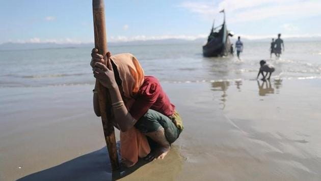 A woman collapses from exhaustion as Rohingya refugees arrive by a wooden boat from Myanmar to the shore of Shah Porir Dwip, in Teknaf, near Cox's Bazar in Bangladesh on October 1. (Reuters) A woman collapses from exhaustion as Rohingya refugees arrive by a wooden boat from Myanmar to the shore of Shah Porir Dwip, in Teknaf, near Cox's Bazar in Bangladesh on October 1. (Reuters)