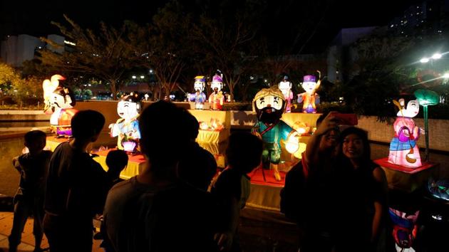 Residents tour a park decorated with lanterns in the shape of traditional Chinese figures during Mid-Autumn, also known as Lantern Festival at a park in Hong Kong. About 461 million Chinese tourists travelled around the country in the first four days of the eight-day long National Day break. (Bobby Yip / REUTERS)