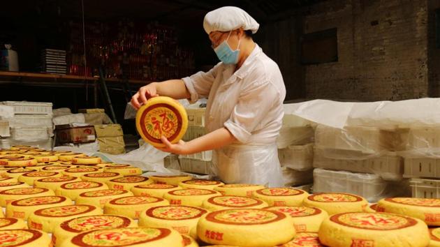 An employee checks freshly baked handmade moon-cakes at a traditional confectionary, ahead of the Mid-Autumn festival, in Zhangjiakou, Hebei province, China. Considered a delicacy, the cakes are offered to friends and at family gatherings. (REUTERS)