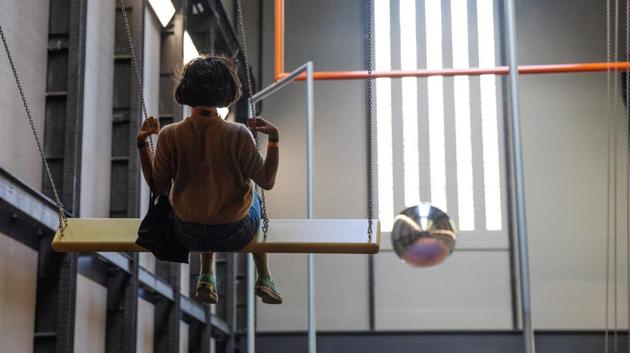 A woman sits on a swing at the new Turbine Hall installation at the Tate Modern in London. The museum has been turned into a playground with visitors encouraged to make new friends while contemplating on bigger issues such as community, capitalism or themselves. (Jack Taylor / Getty Images)