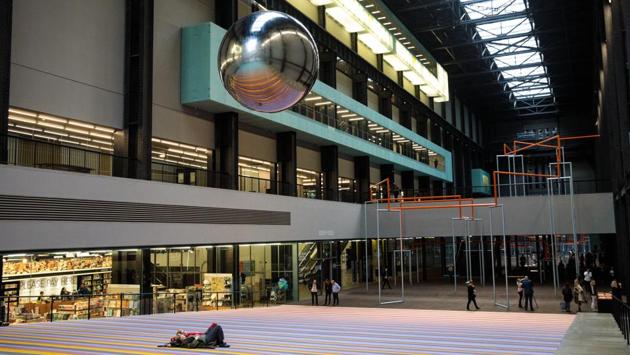 People lie beneath a pendulum at the Tate Modern in London. For the less active, visitors can lie on a carpet and be hypnotized by a large mirrored ball swinging from the ceiling. (Jack Taylor / Getty Images)