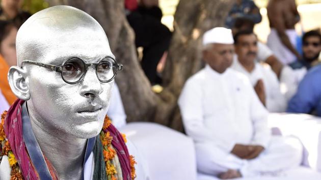 A supporter of Anna Hazare impersonates the ‘Father of the Nation’ Mahatma Gandhi during Hazare’s day-long hunger strike for implementation of the Lokpal Bill on the birth anniversary of Mahatma Gandhi on Monday. (Ajay Aggarwal / HT Photo) A supporter of Anna Hazare impersonates the ‘Father of the Nation’ Mahatma Gandhi during Hazare’s day-long hunger strike for implementation of the Lokpal Bill on the birth anniversary of Mahatma Gandhi on Monday. (Ajay Aggarwal / HT Photo)