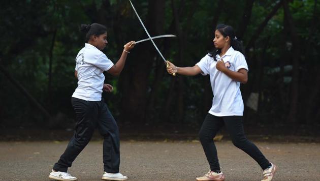 Purvi Ganve (R) and Samruddhi Jadhav (L) engage in s friendly sword fight to demonstrate the various defensive and offensive movements. (Pratham Gokhale/HT Photo) 