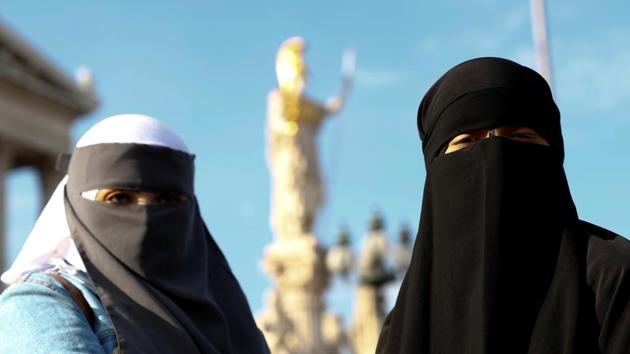 Demonstrators covering their faces participate in a protest called "The traditional clown's walk against the burqa ban" in Vienna, Austria October 1, 2017. (REUTERS)