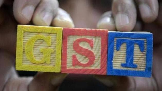 A consumer goods trader shows letters GST representing "Goods and Services Tax" (GST)at his shop in Hyderabad.(AFP File Photo)