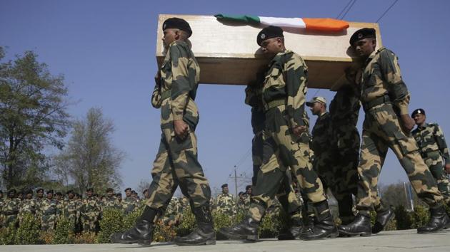 Indian Border Security Force (BSF) soldiers carry the coffin of their slain colleague during a wreath-laying ceremony on the outskirts of Srinagar on Wednesday. The BSF officer was killed along with three suspected militants when a group of rebels stormed a paramilitary camp near the airport in Kashmir early Tuesday. (Mukhtar Khan / AP) Indian Border Security Force (BSF) soldiers carry the coffin of their slain colleague during a wreath-laying ceremony on the outskirts of Srinagar on Wednesday. The BSF officer was killed along with three suspected militants when a group of rebels stormed a paramilitary camp near the airport in Kashmir early Tuesday. (Mukhtar Khan / AP)