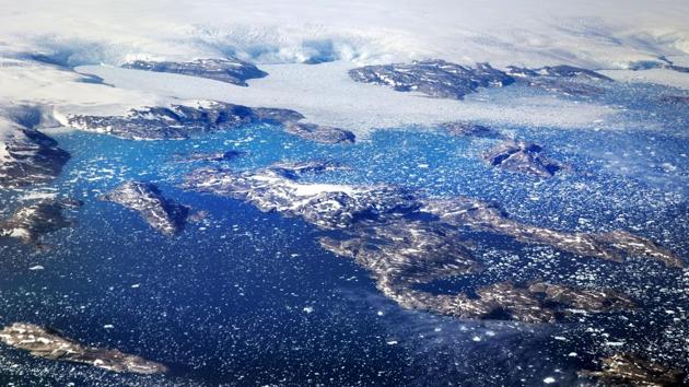 Icebergs float in a fjord after calving off from glaciers on the Greenland ice sheet. The ice sheet, the second largest body of ice in the world, which covers roughly 80 percent of the country, has been retreating at an accelerated pace in recent years due to warmer temperatures. (David Goldman / AP)