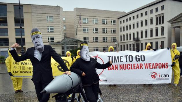 Picture taken on September 13, 2017 shows activists of the International campaign to abolish Nuclear Weapons (ICAN) wearing masks of US President Donald Trump (L) and North Korea's leader Kim Jong-un as they demonstrate in front of the US embassy in Berlin. The world's nuclear powers must begin "serious negotiations" aimed at disarmament, the Nobel committee said as it awarded its prestigious Peace Prize to non-proliferation pressure group ICAN.(AFP Photo)