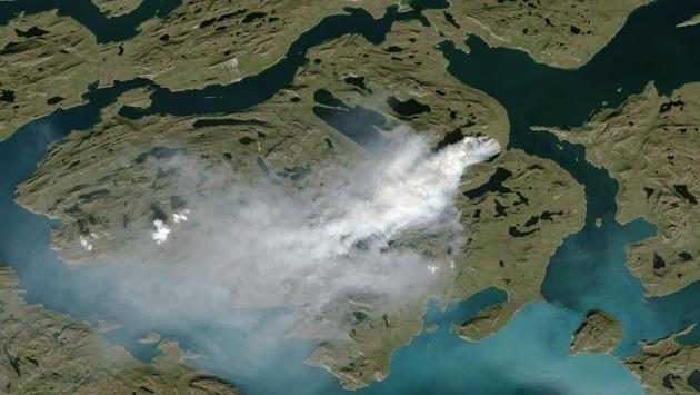 A cloud of smoke is seen from wildfires burning in Greenland. Although it was not clear, a lack of documented lightning prior to its ignition suggests that the fire was probably triggered by human activity. (AFP PHOTO / NOAA/ HANDOUT)