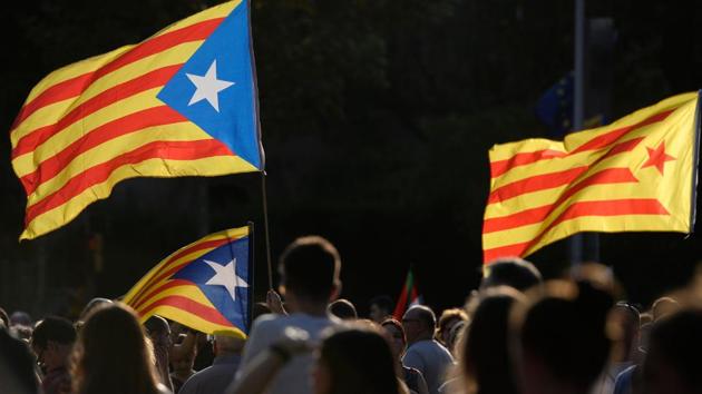 People hold Catalan pro-independence 'Estelada' flags in Barcelona during a general strike in Catalonia.(AFP Photo)