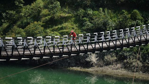 Gurman Reen Singh of India is seen riding on a narrow bridge over a river near Mandi in Himachal Pradesh. Spread over 650 kilometres, the race lasted eight days before finally culminating in Dharamshala. (AFP / SAJJAD HUSSAIN) Gurman Reen Singh of India is seen riding on a narrow bridge over a river near Mandi in Himachal Pradesh. Spread over 650 kilometres, the race lasted eight days before finally culminating in Dharamshala. (AFP / SAJJAD HUSSAIN)